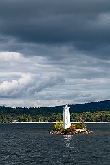 Sun Breaks Through Swirling Clouds by Loon Island Light in NH